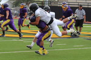 Junior Grant Petty catches a Pecos player from behind and drags him down during the Aug. 15 scrimmage.